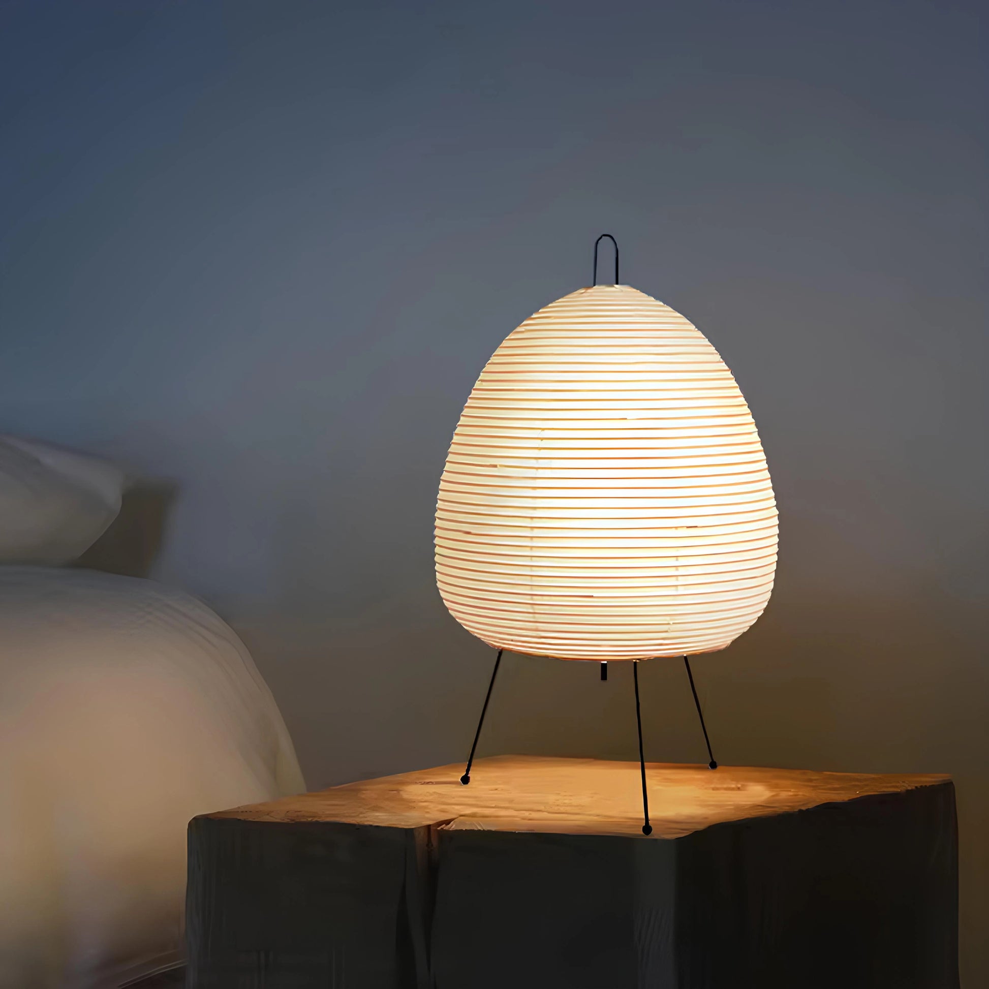 Lummero - table lamp with woven design on a wooden surface against a dark background