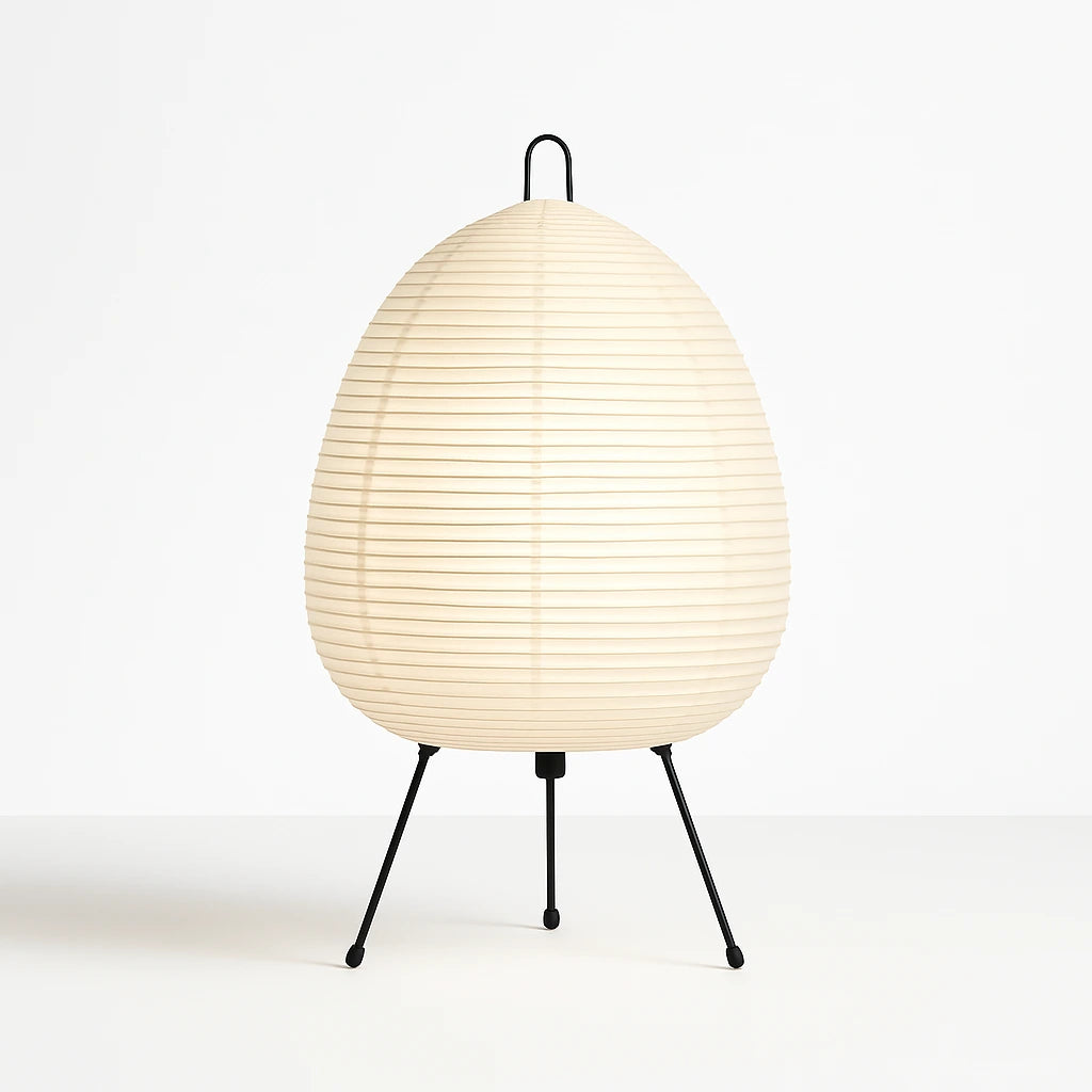 Lummero - table lamp with a white woven shade and black metal legs on a white background